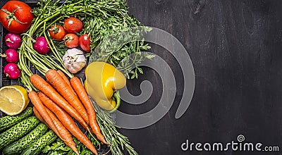 Colorful various organic farm vegetables carrots cherry tomatoes, garlic, cucumber, lemon, pepper, radish, wooden spoon salt peppe Stock Photo