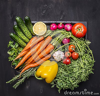 Colorful various of organic farm vegetables in a wooden box on wooden rustic background top view close up Stock Photo
