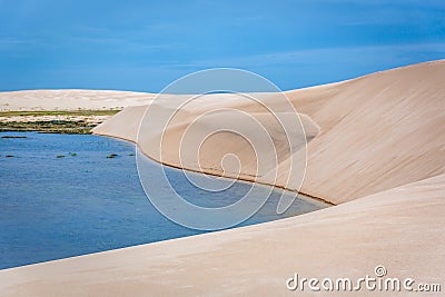 The colorful vast desert landscape of tall, white sand dunes and seasonal rainwater lagoons at the LenÃ§Ã³is Maranhenses National Stock Photo