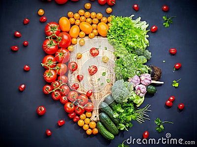 Colorful vegetables composition with red and yellow tomatoes, cucumbers, greens. Top view. Stock Photo