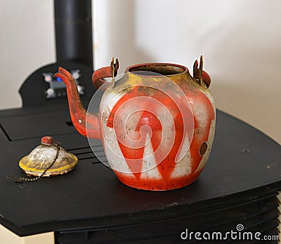 colorful vintage dirty and dusty teapot on an oven Stock Photo