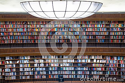 Colorful wall of books on the shelfs at the rotunda in Stockholm Stadsbibliotek or Public Library Stock Photo