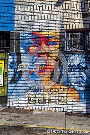 A colorful wall mural of two women wearing gold teeth in Little Five Points in Atlanta Georgia Editorial Stock Photo