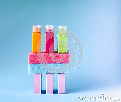 Colorful washcloths, plastic travel bottles and bars of soap on a soft background. Accessories for body care and hygiene Stock Photo