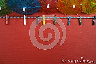 Colorful washline with clothespins and paper umbrellas, copy spa Stock Photo