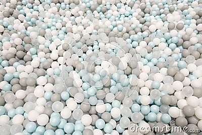 Colorful white, grey, blue plastic balls background for baby activity. Kid's playing room interior. Copyspace Stock Photo
