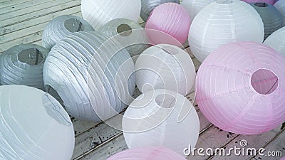 Colorful white pink gray paper lanterns set on floor. Stock Photo