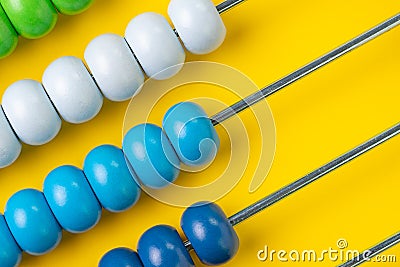 Colorful wooden abacus beads on yellow background, business financial or accounting cost and expense calculation concept, or use Stock Photo