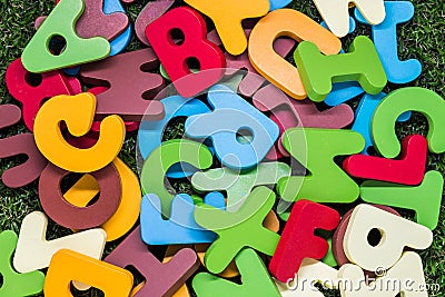 Colorful wooden alphabet on green grass Stock Photo