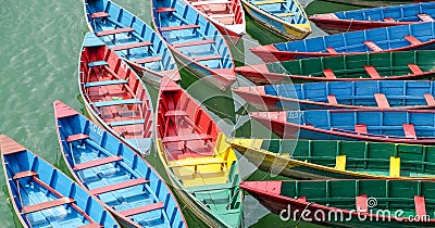 Colorful wooden boats in the dock on Fewa Lake in Pokhara, Nepal Stock Photo