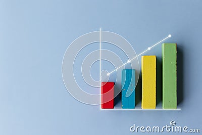 Colorful wooden toy block financial bar chart graph with upward trend line on blue color background Stock Photo