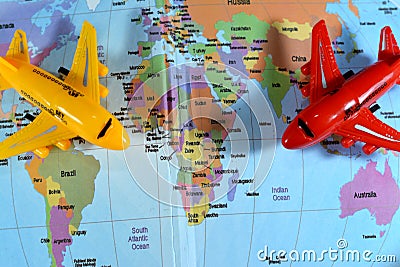 Colorful world map with airplane on it with the continents Africa, Europe, North America, Asia, South America, Australia and Stock Photo