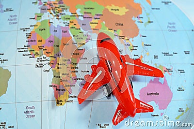 Colorful world map with airplane on it with the continents Africa, Europe, North America, Asia, South America, Australia and Stock Photo