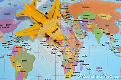 Colorful world map with airplane on it with the continents Africa, Europe, North America, Asia, South America, Australia and Stock Photo