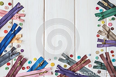 Colorful zippers and buttons on a wooden table. Rustic style. Needlework. ÃÂ¡opy space. Stock Photo