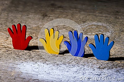 Colorfull puzzles hands on wooden table. World Autism Awareness Day Concept Stock Photo