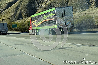 Eighteen wheeler semi truck driving down a mountain Stock Photo