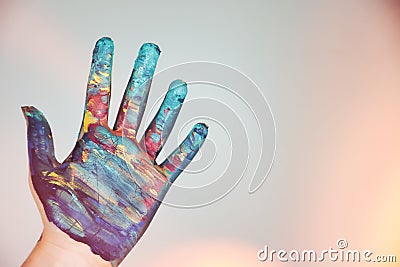 A colorfully painted hand on a white background Stock Photo