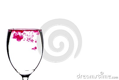 Coloring diffuse in water inside wine glass Stock Photo