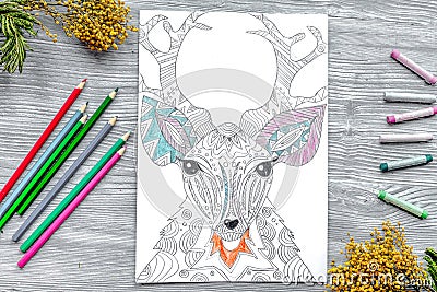 Coloring picture for adults on wooden background top view Stock Photo