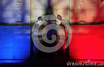 The colors of France on statue of veterans in night Editorial Stock Photo