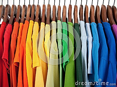 Colors of rainbow, clothes on wooden hangers Stock Photo