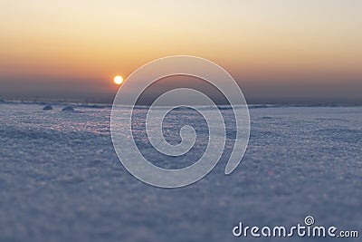 Sunset over the snowy plain Stock Photo