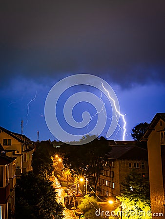 Colosal lightning hits the ground during a storm at night Stock Photo