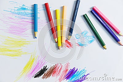 Colour pencils on white paper background paint education concept - wooden crayon multicolored drawings Stock Photo