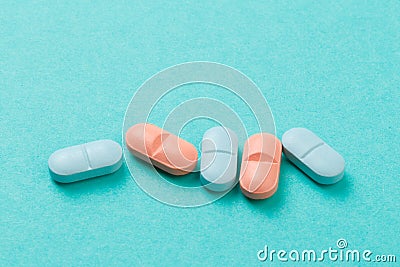 Colour tablets and pills on blue background Stock Photo