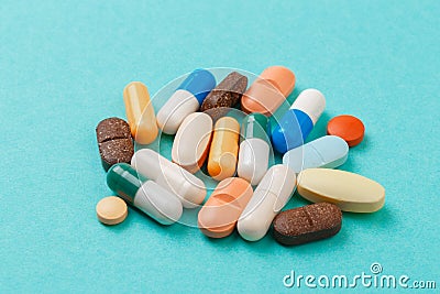 Colour tablets and pills on blue background Stock Photo