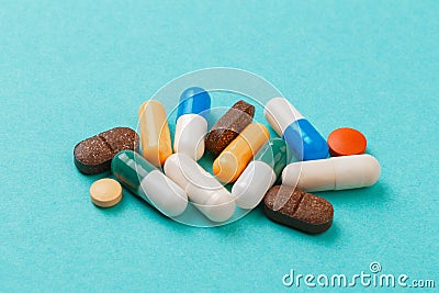 Colour tablets and pills on blue background Stock Photo