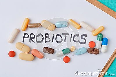 Colour tablets and pills on blue background probiotic theme - Image Stock Photo