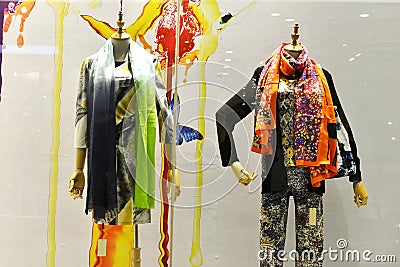 Coloured and patterned scarves in shop window Stock Photo