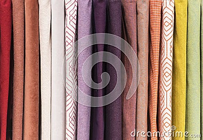 Coloured patterned textured fabric on a rack Stock Photo