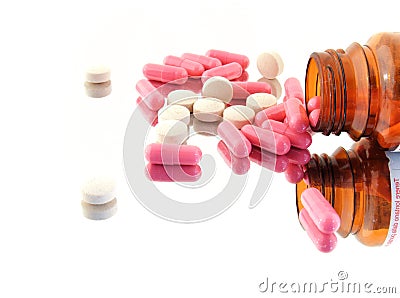 Coloured pills on a mirror Stock Photo