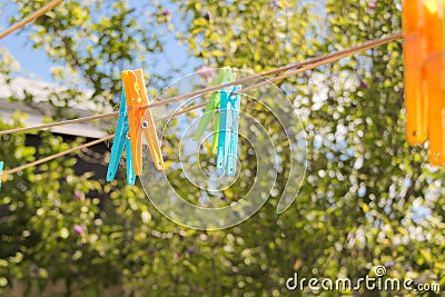 Coloured plastic pegs on the clothes line in Australian summer Stock Photo