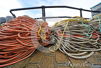 Coloured ropes on harbour quay Stock Photo