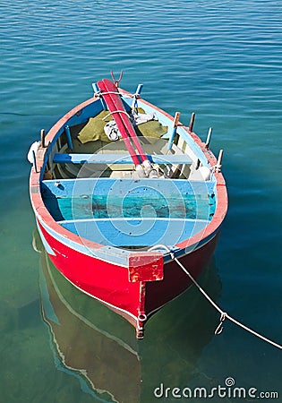 Coloured rowboat in clear sea. Stock Photo