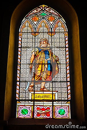 Coloured stained glass window colored in a dark background church with Zerubbabel bible character Stock Photo