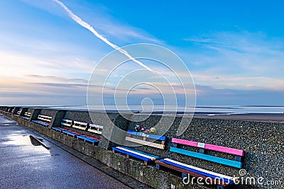 Colourful benches along New Brighton Promenade Stock Photo