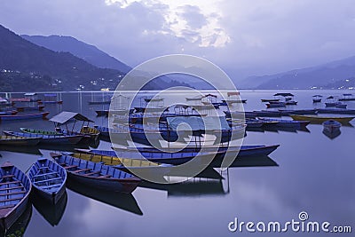 Colourful boats at shore of beautiful Phewa lake Editorial Stock Photo