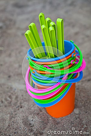 Colourful buckets on a sandy beach Stock Photo