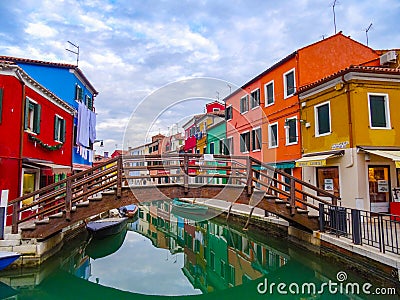 The amazing colourful buildings of Burano with a bridge over the canal in Italy Editorial Stock Photo