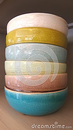 Colourful ceramic bowl in kitchen cabinet Stock Photo