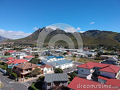 Small coastal town nestled nearby a beautiful mountain range Stock Photo