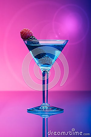 Colourful cocktails garnished with berries, background with light effects Stock Photo