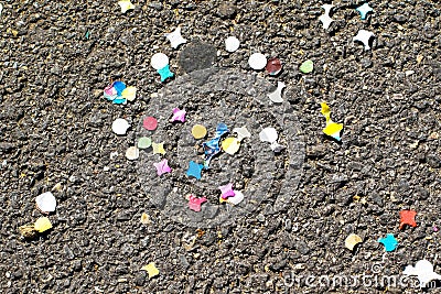 Colourful confetti on the ground after carnival. Confetti on the ground after the holidays. Background. Stock Photo