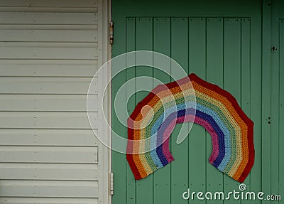 Colourful crocheted rainbow, a symbol of gratitude to the National Health Service NHS during the Coronavirus pandemic in the UK. Stock Photo