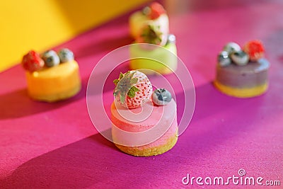 Colourful dessert with berries. Cheese cakes with blueberries and strawberry. Restaurant menu. Food background. Beautiful meal. Stock Photo